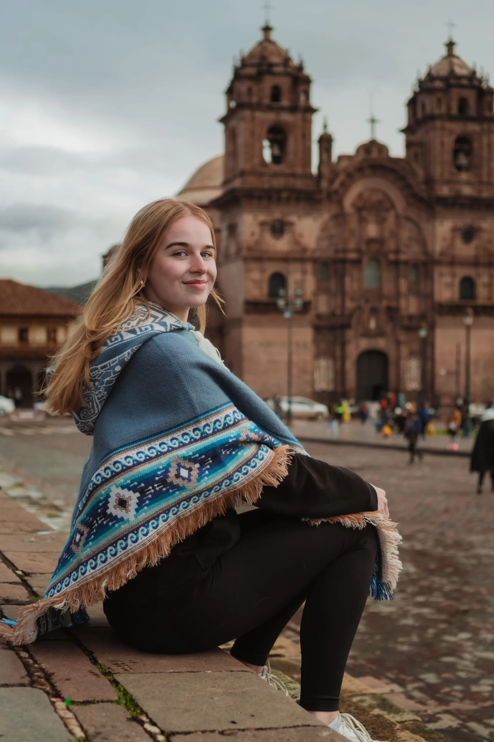 Solo traveler sitting in front of the Cathedral during a city tour with Amaiaq.