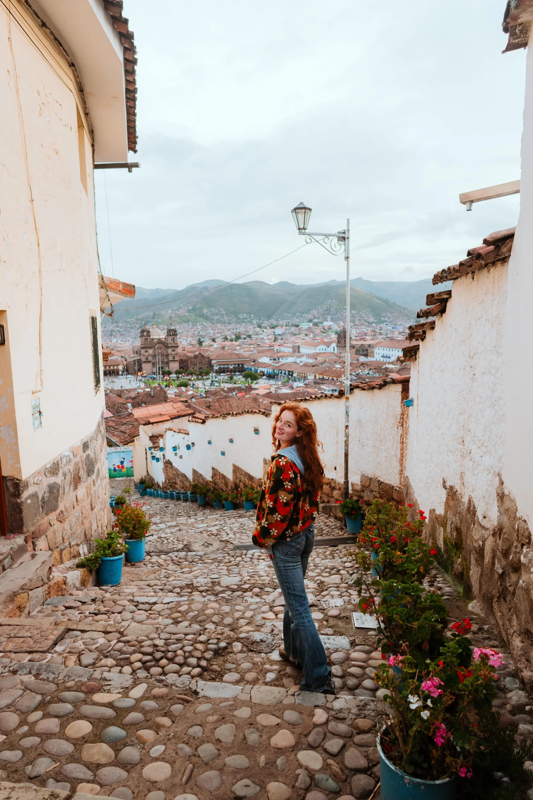 Traveler exploring the cobbled streets of Cusco City, this street is called La Resbalosa.