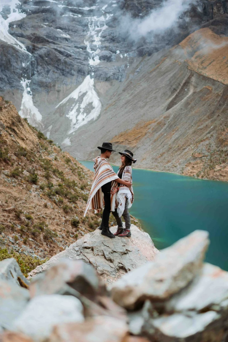 Couple taking photos at a panoramic spot near Humantay Lake