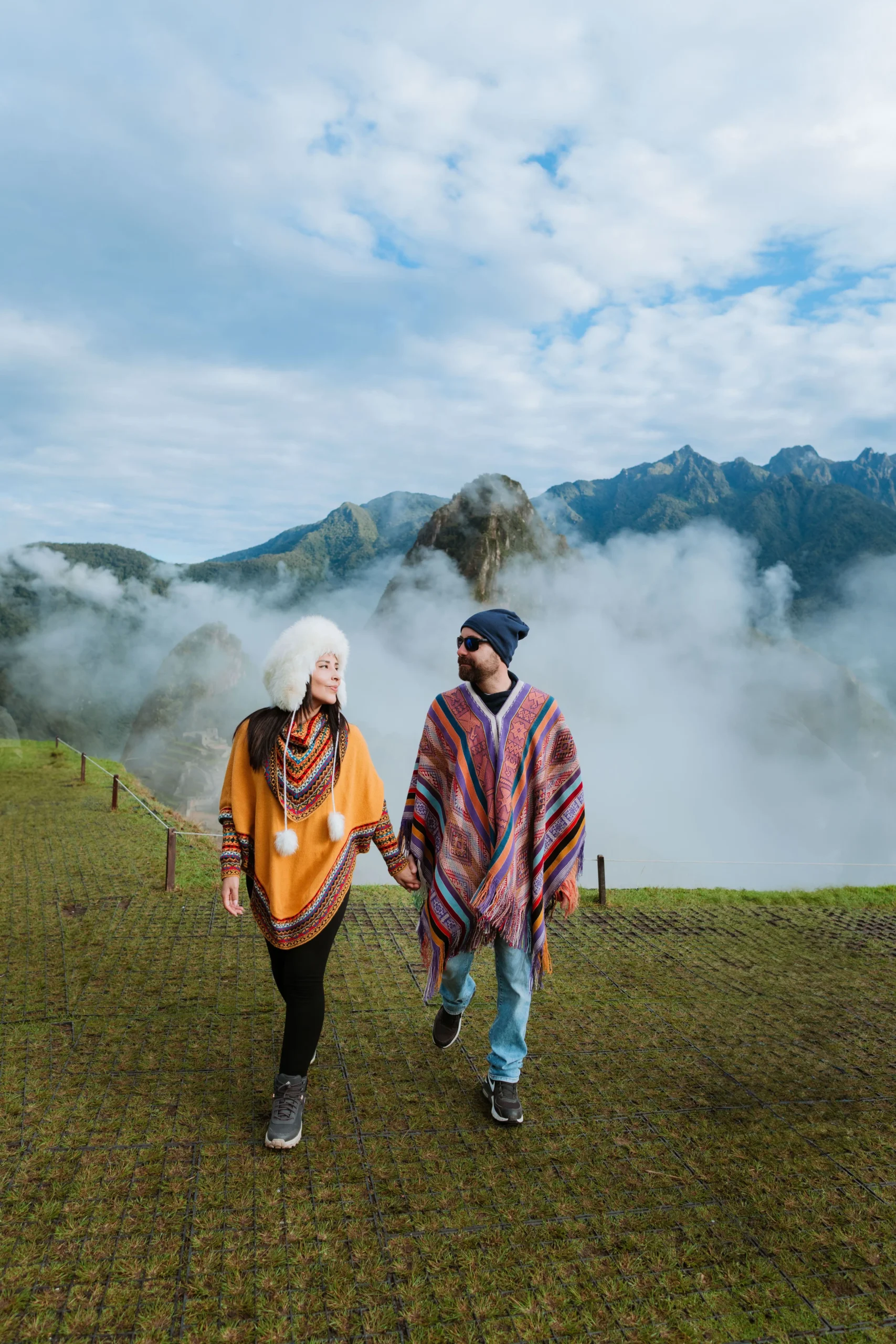 Tourists walking through the cloudy trails of Machu Picchu