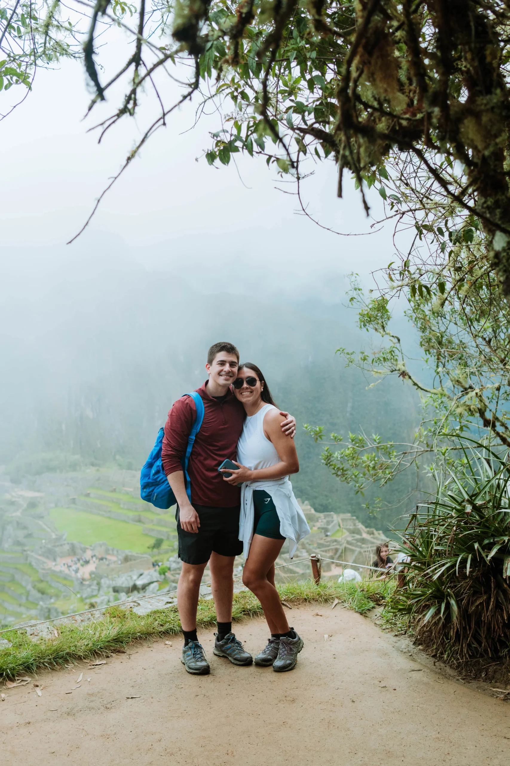 Couple hiking a lush pathway in Machu Picchu