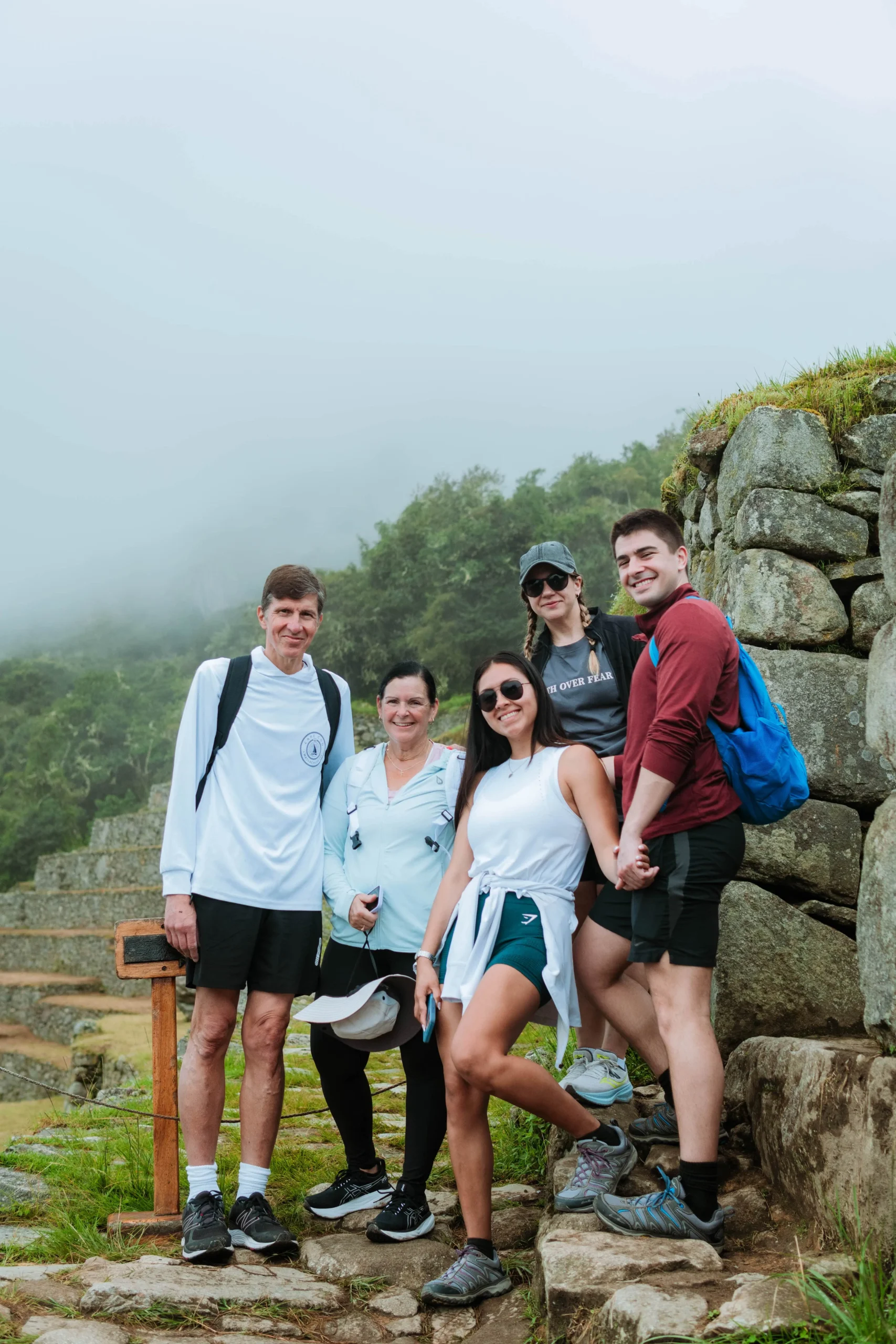 Family posing together along the trail at Machu Picchu.