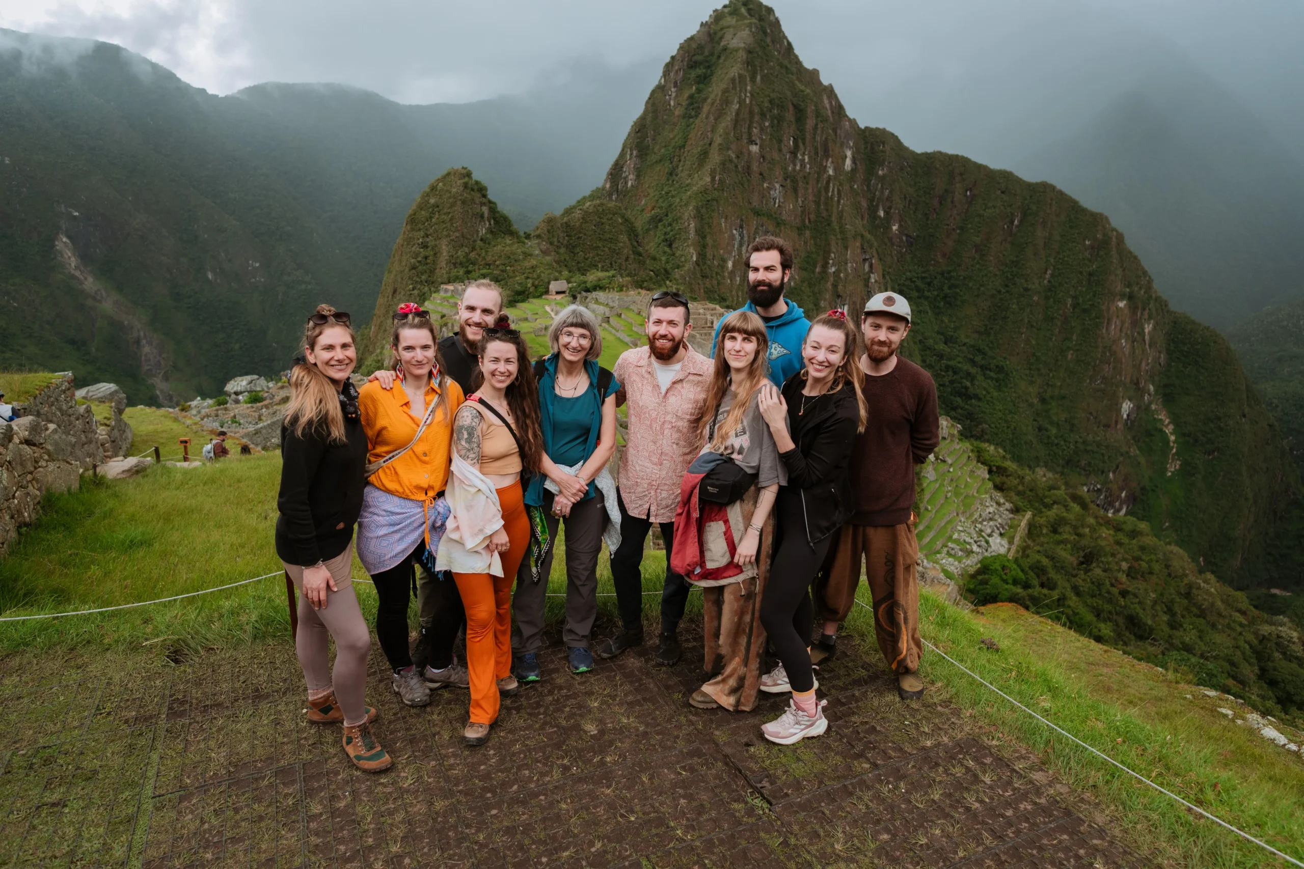 Tourists posing for a photo at the iconic Machu Picchu ruins