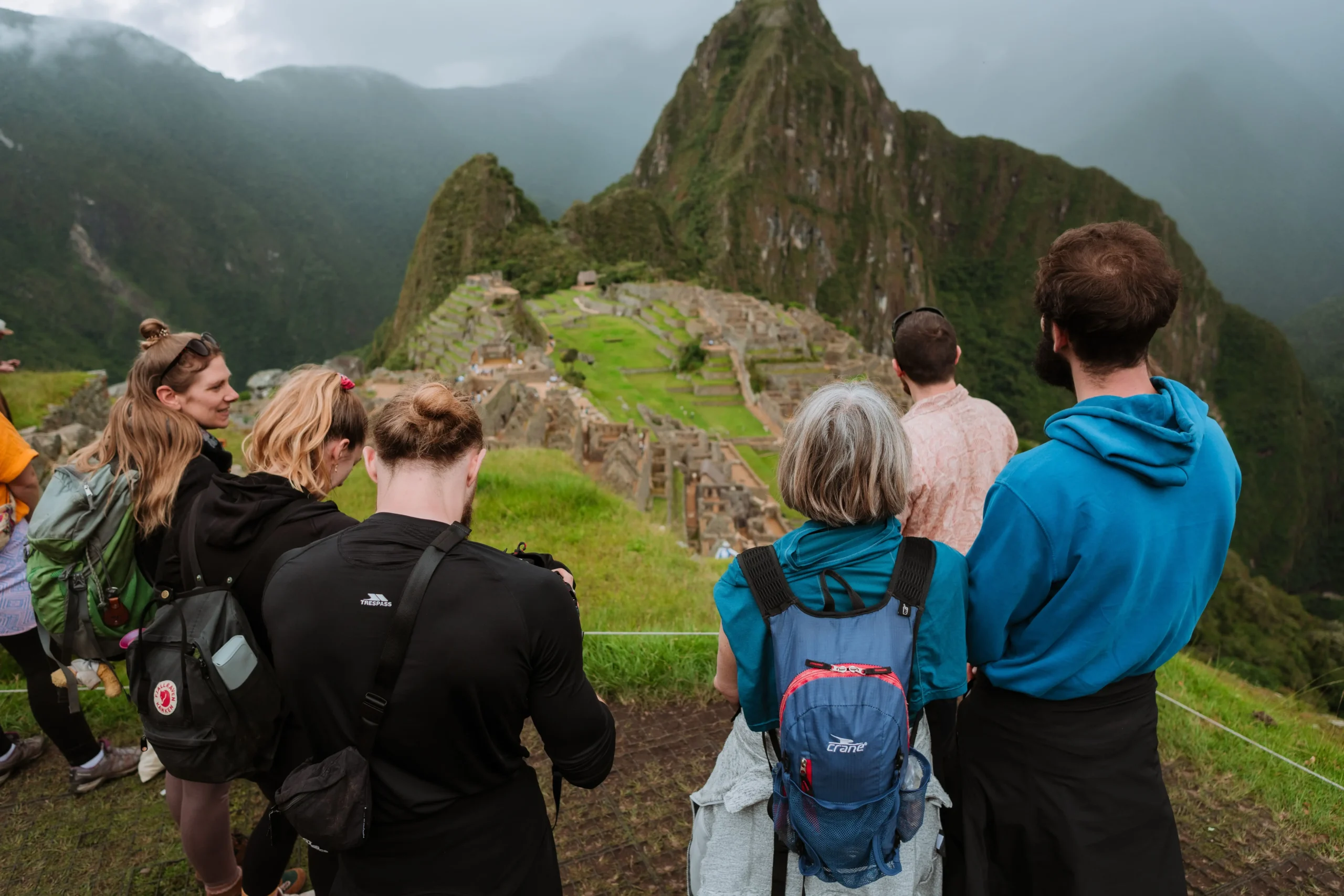 Tour group listening to a guide at Machu Picchu
