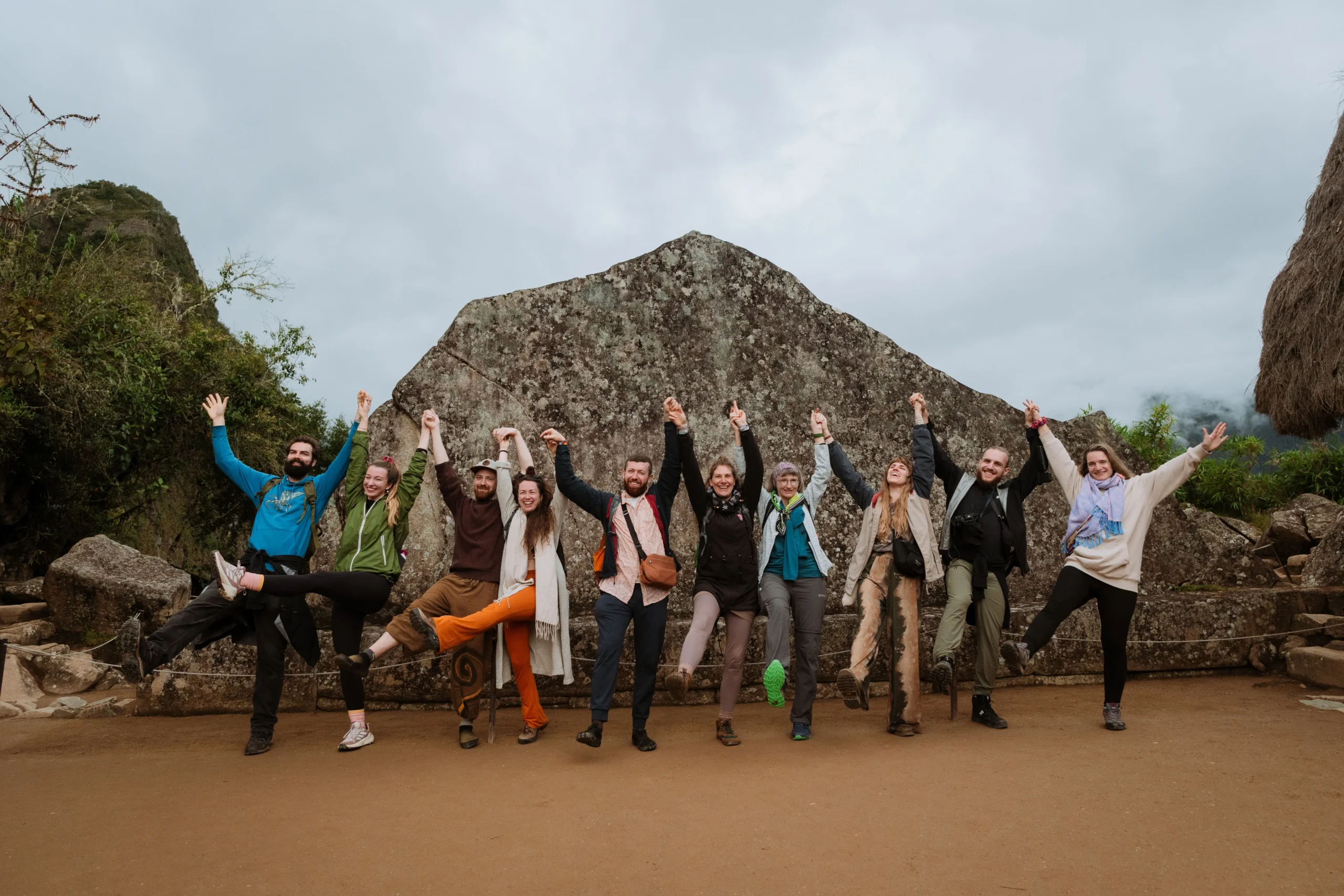 Hiking group celebrating at Machu Picchu viewpoint