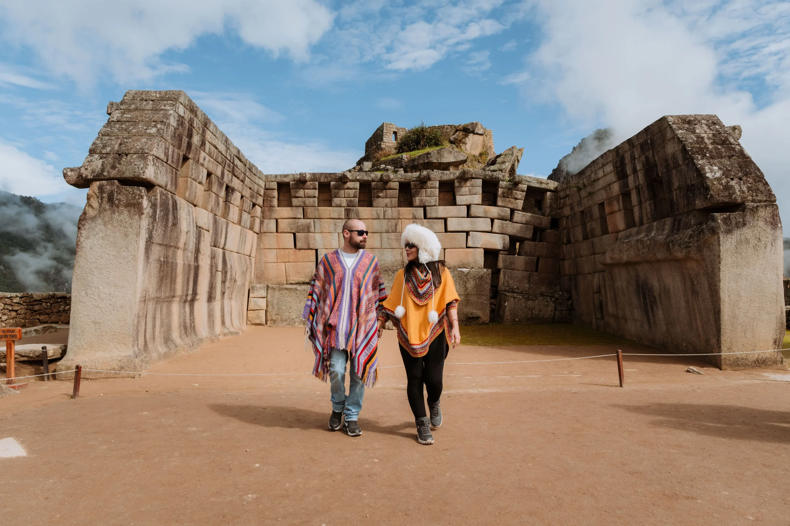 Tourists walking through historic ruins in Machu Picchu