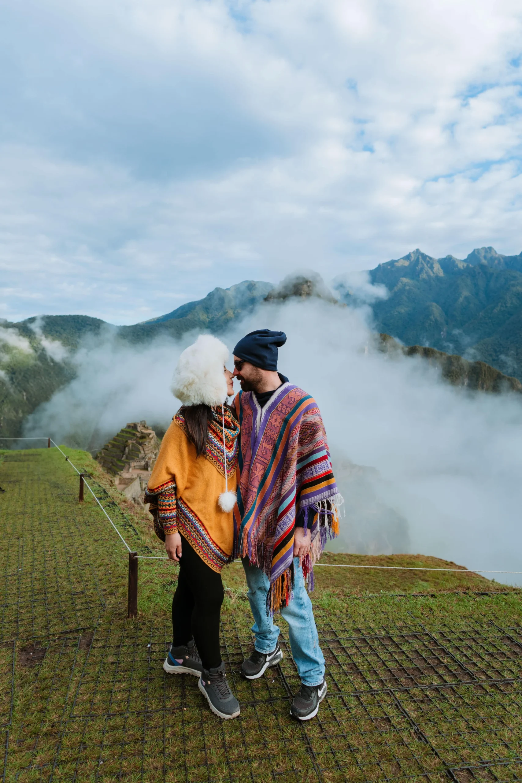 Couple enjoying the view of the Andes from Machu Picchu