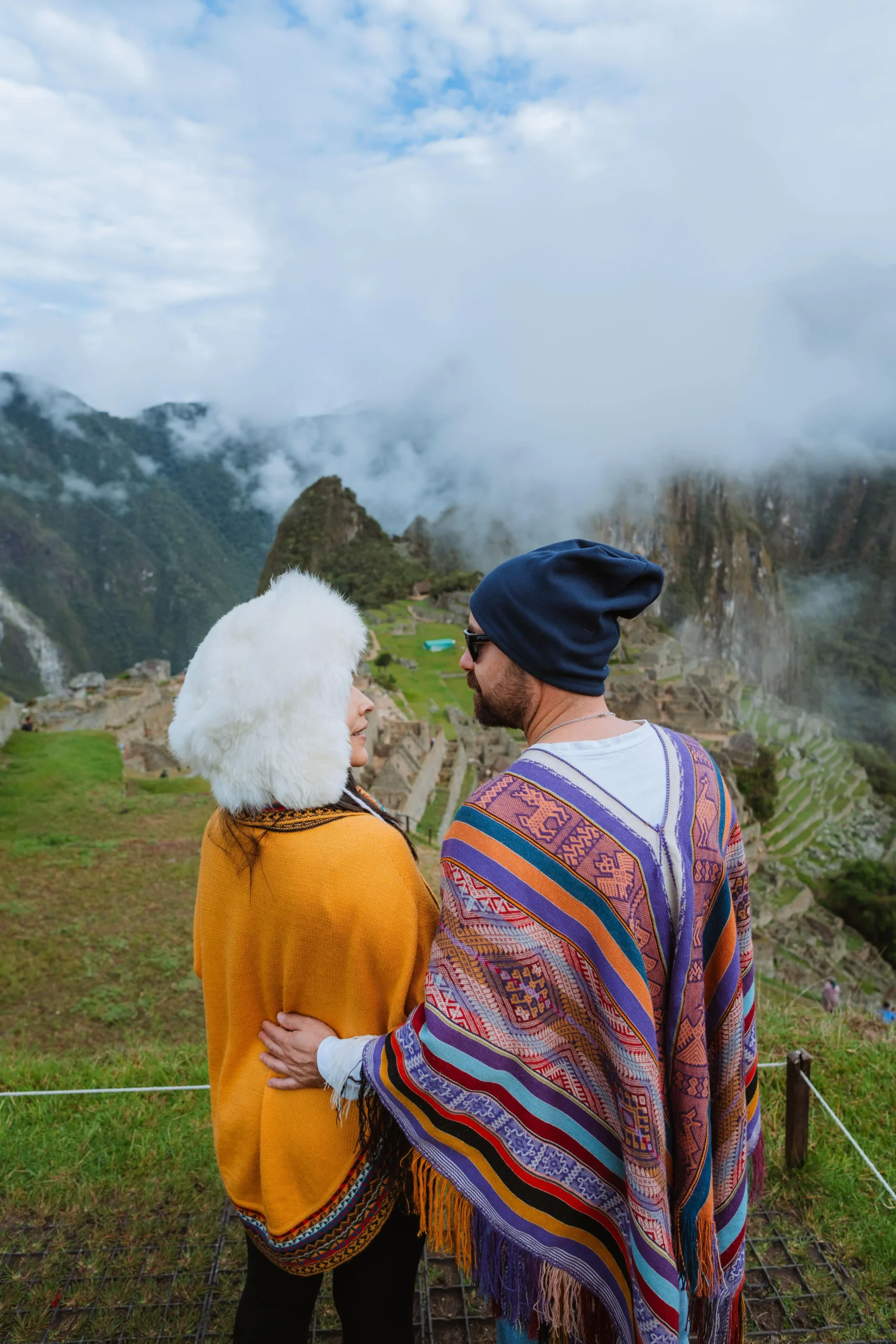 Couple enjoying sunset views at Machu Picchu ruins