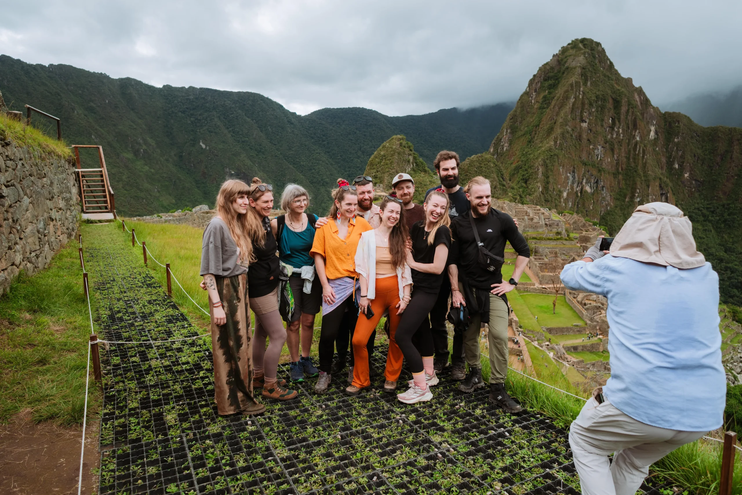 Tourists posing for a photo at the iconic Machu Picchu ruins
