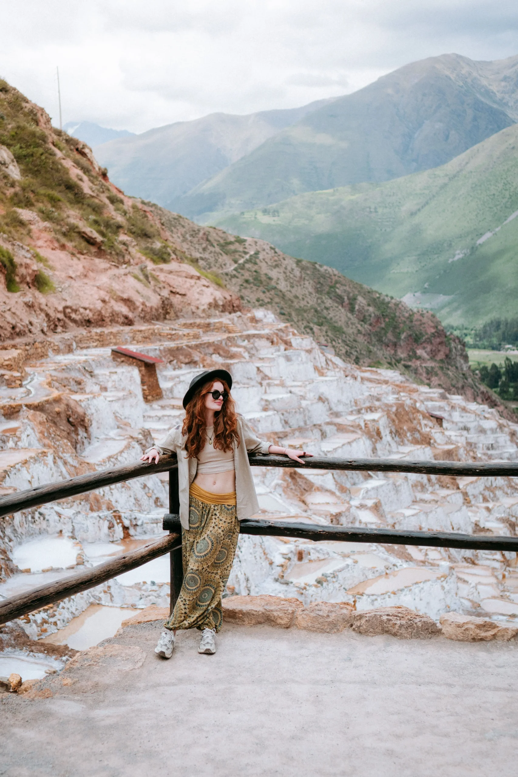 Woman standing beside the salt terraces at Maras