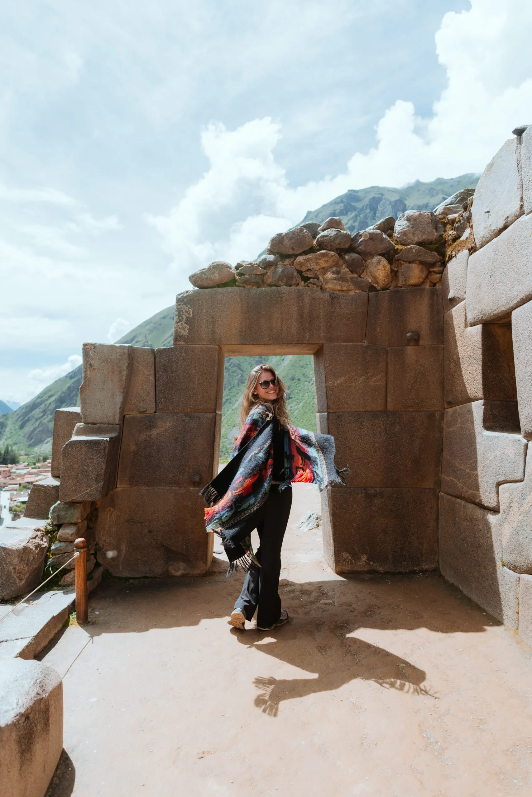 Traveler posing near ruins at Ollantaytambo