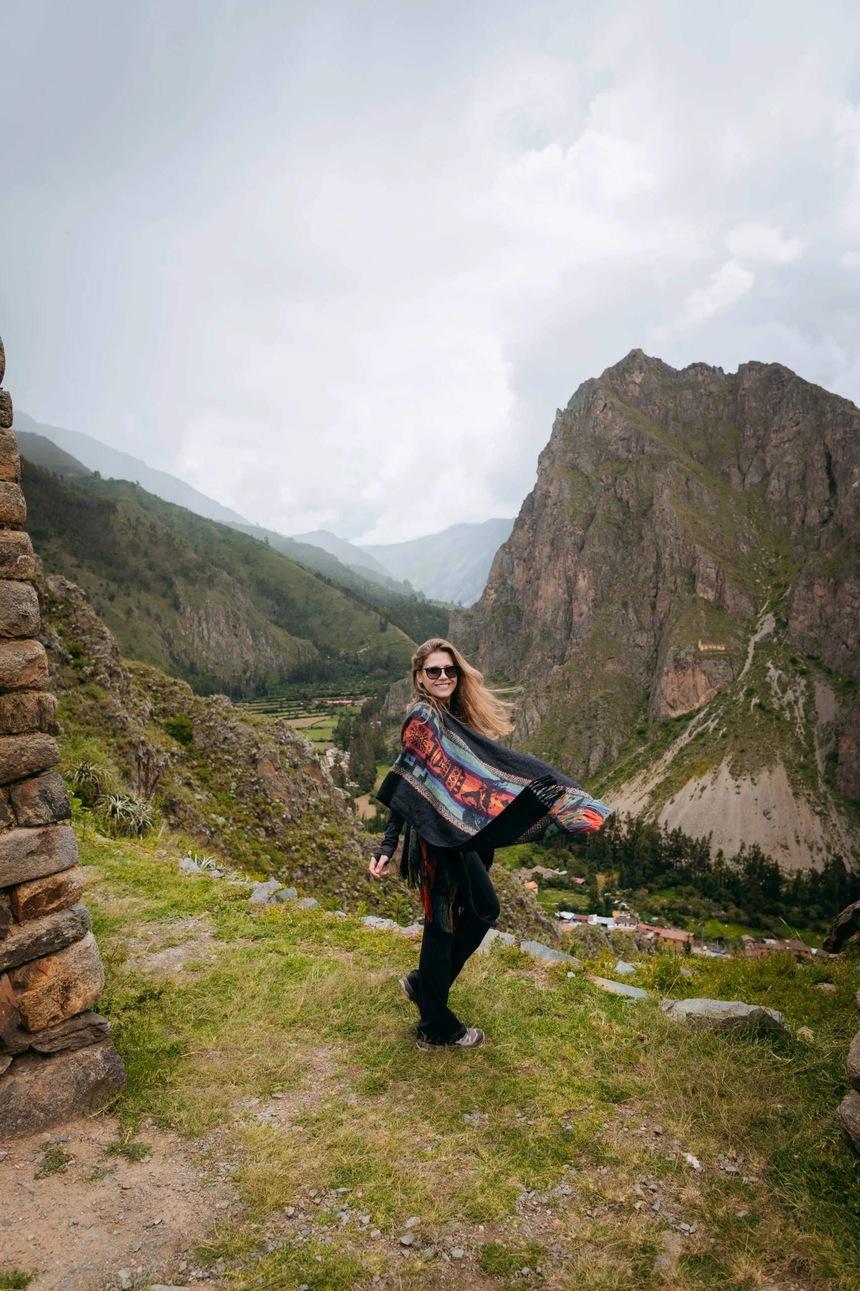 Tourist sitting on the ancient steps of Ollantaytambo