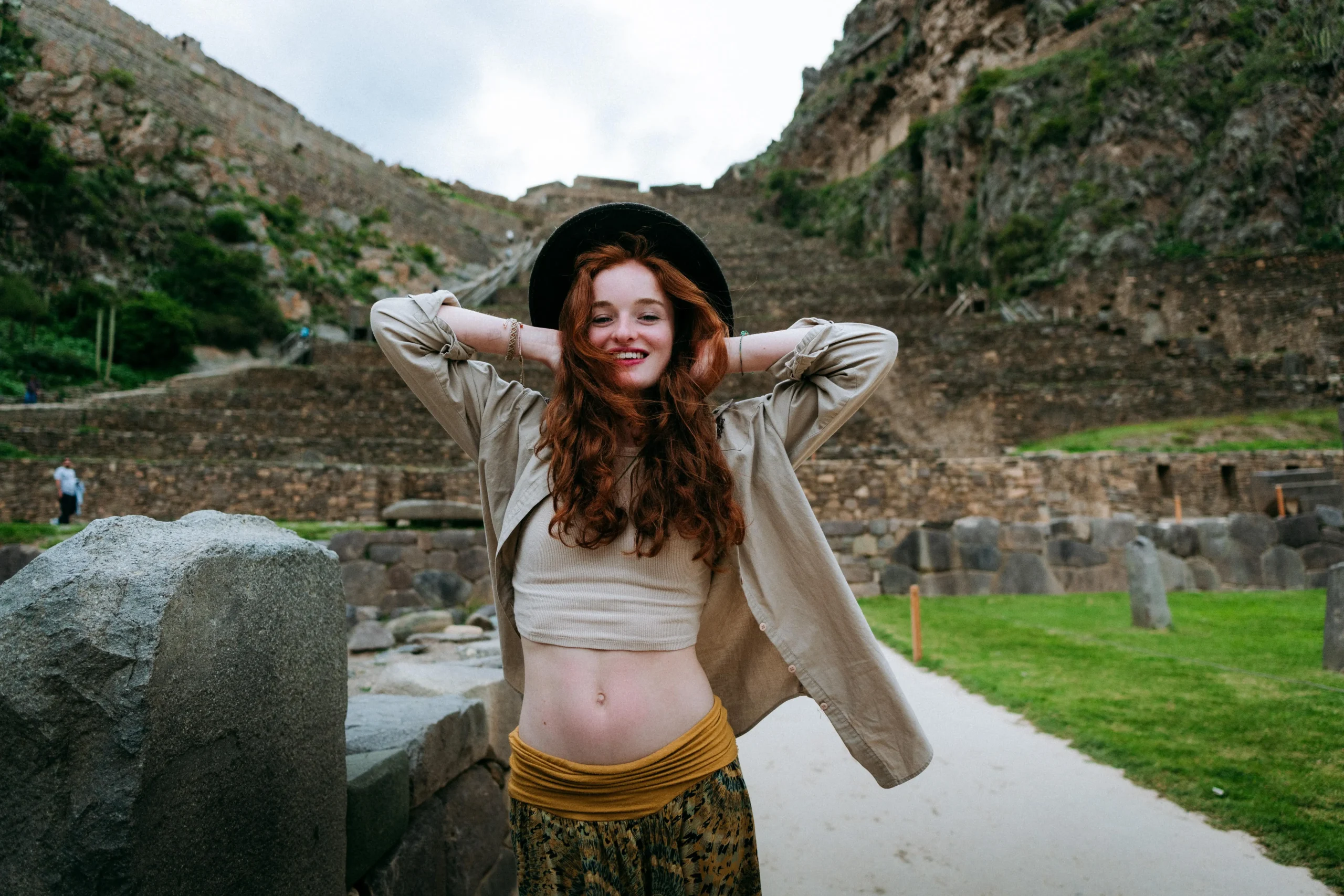 Solo traveler posing in Ollantaytambo ruins, photo tour session with Amaiaq.