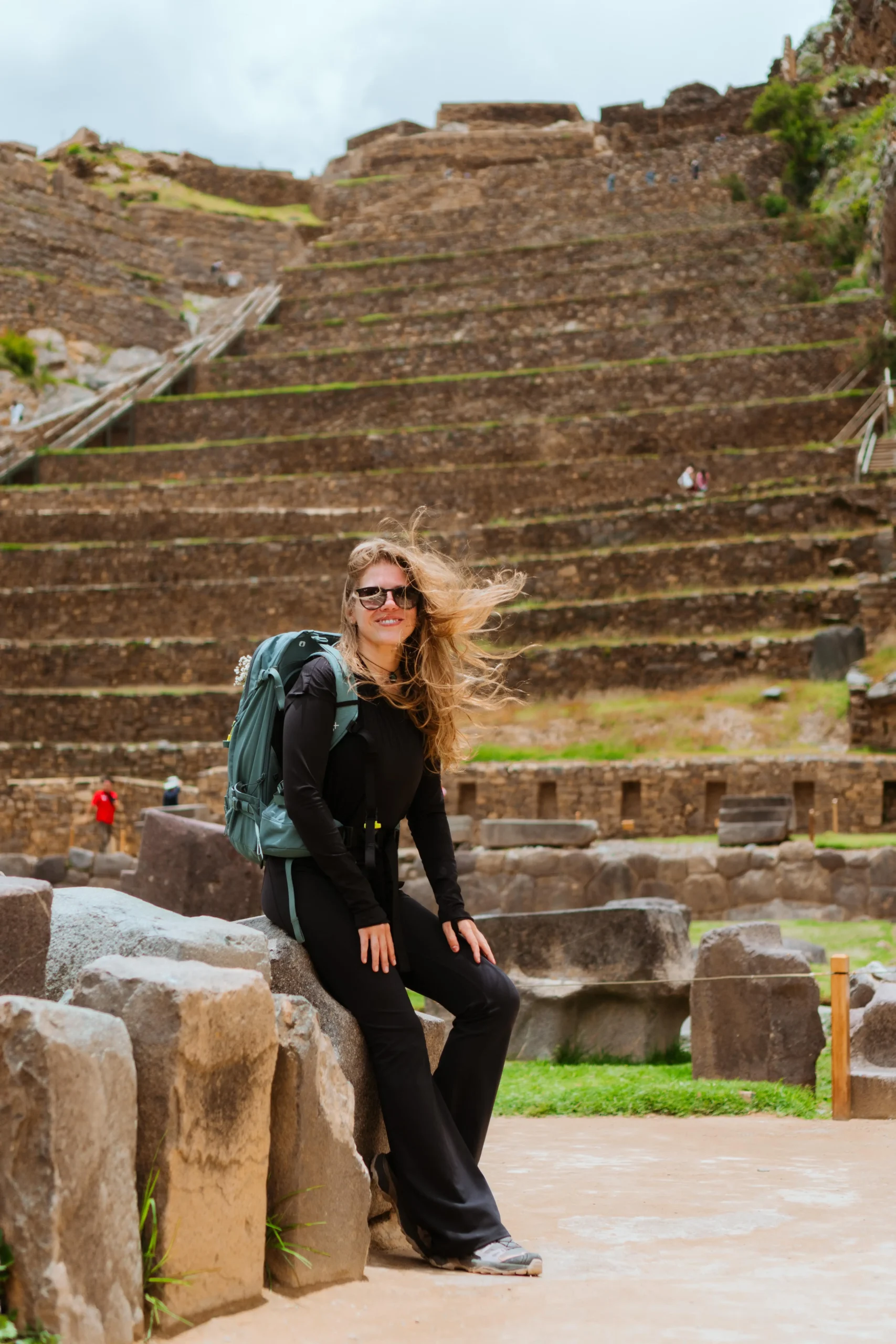 Solo traveler visiting ancient stone walls in Ollantaytambo ruins